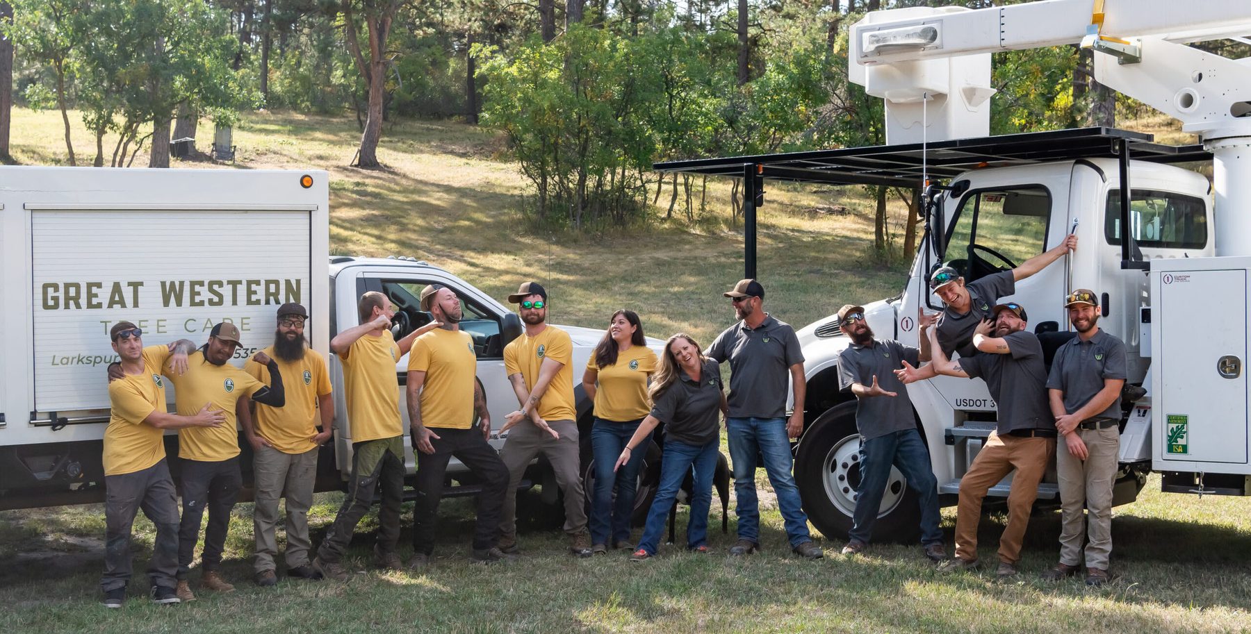 The Great Western Tree Care crew lined up in company shirts in front of their equipment truck