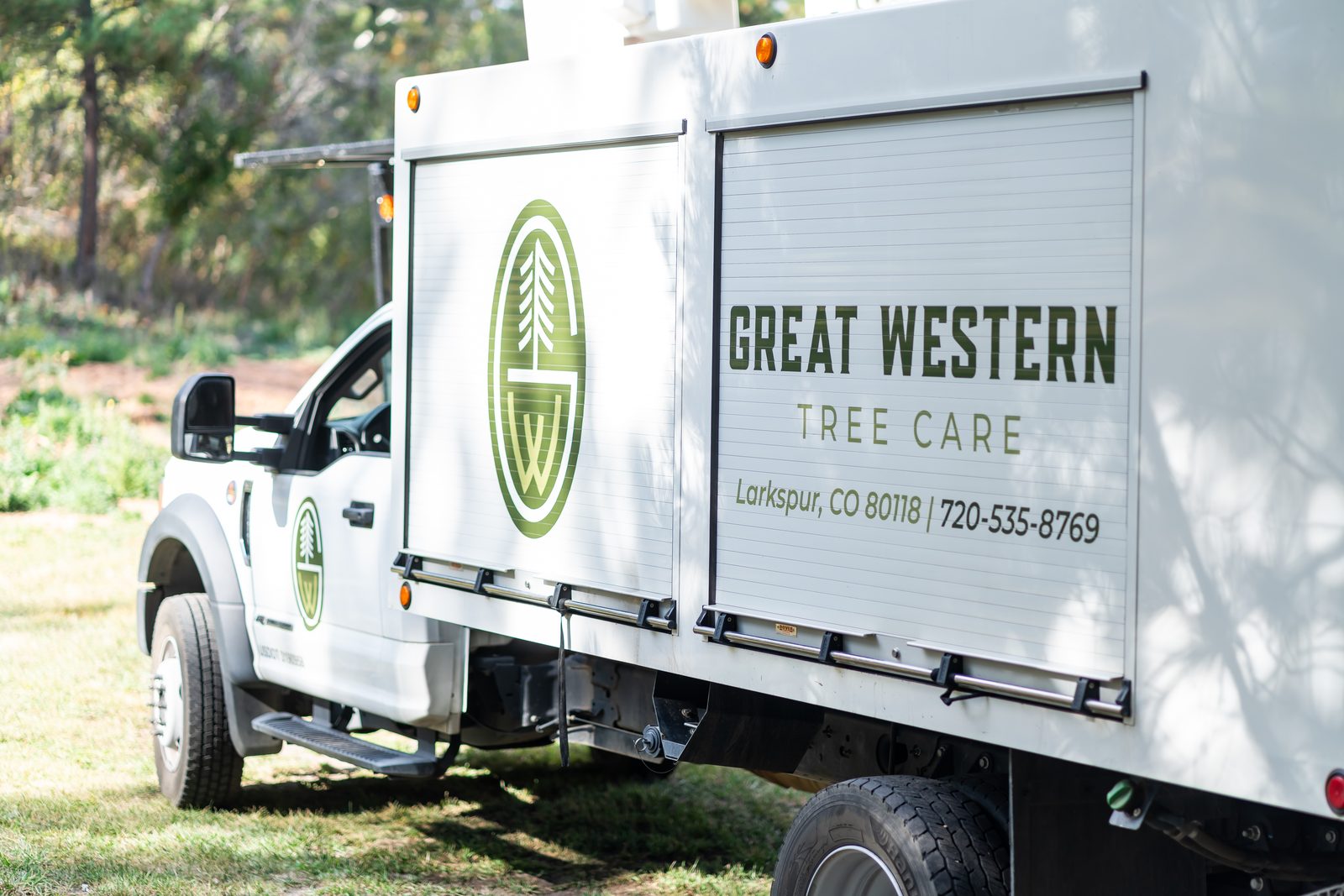 Great Western Tree Care branded box truck parked on a residential job site